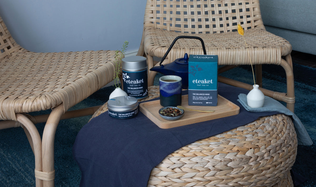 eteaket functional tea The Balanced Mind  in retail cartons & tins, being served in a traditional cast iron teapot.