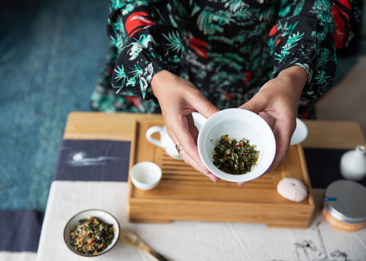 Erica Moore, eteaket founder, holds functional tea blend The Contented Mind in a traditional Chinese Gaiwan.